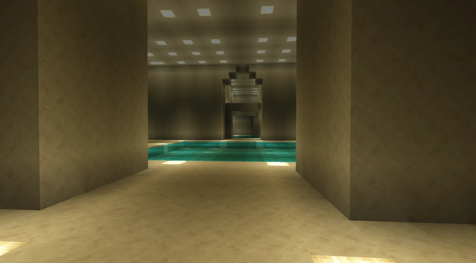 A pool and a white hall with a structure at the far end