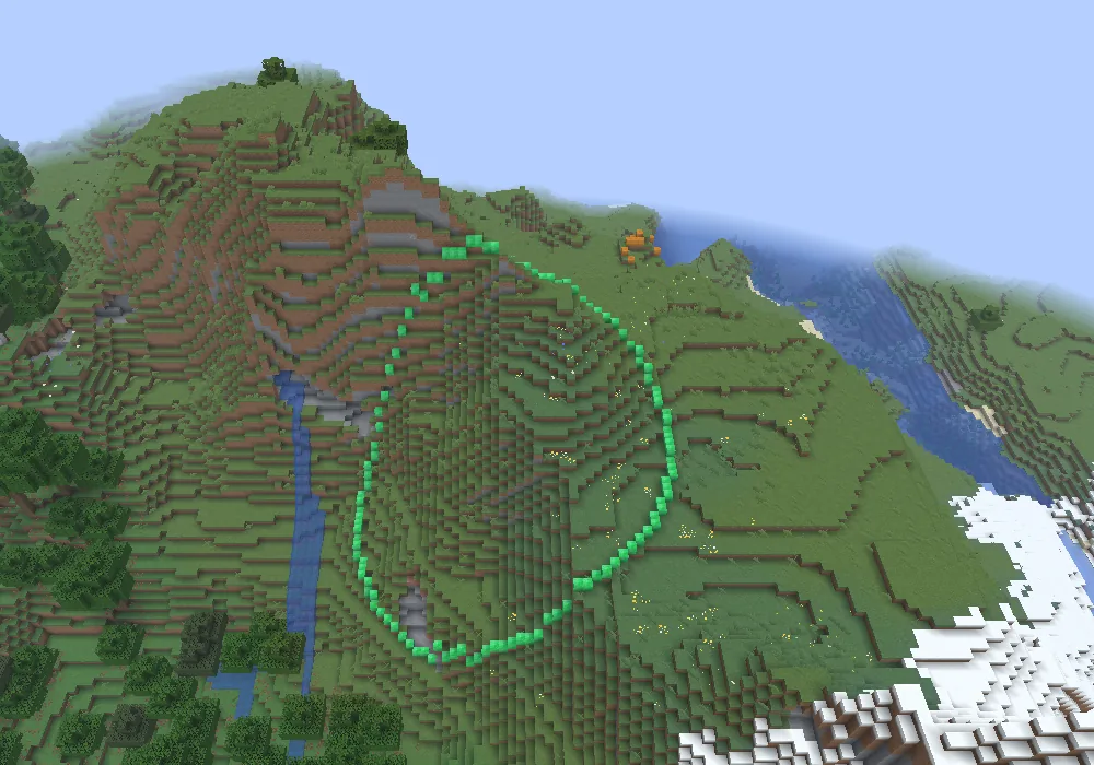 Aerial view of a green line of emerald blocks circling a mountain