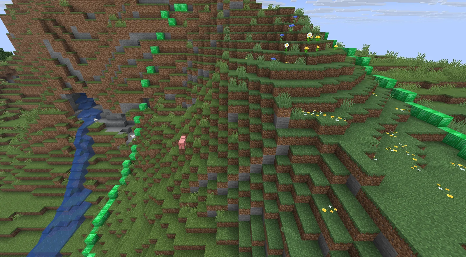 Emerald blocks following the slope of a hill